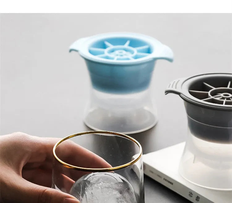 Silicone ice tray with 12 colour and shape options for making large ice cubes, including hockey pucks and geometric forms, measuring 23 x 15 x 4 cm to fit most freezer compartments.