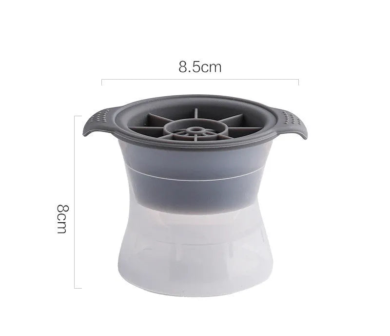 Silicone ice tray in various colours making large ice cubes, including hockey puck and geometric shapes, on a kitchen counter