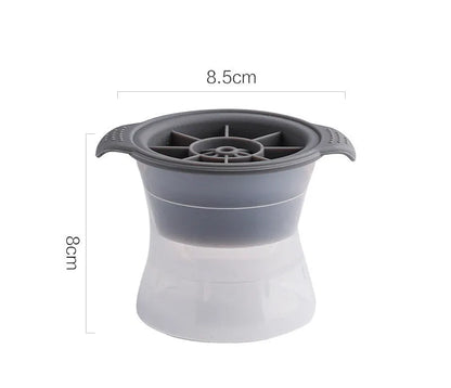 Silicone ice tray in various colours making large ice cubes, including hockey puck and geometric shapes, on a kitchen counter