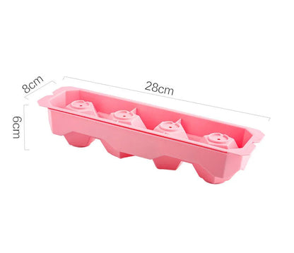 Silicone ice tray in various colours making large ice cubes, including hockey puck and geometric shapes, on a kitchen counter