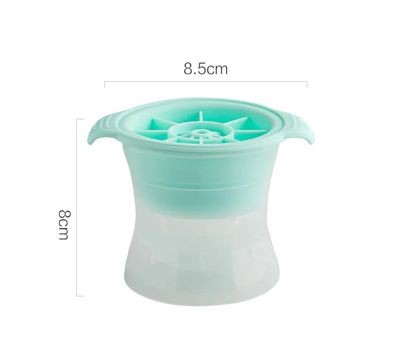 Silicone ice tray in various colours making large ice cubes, including hockey puck and geometric shapes, on a kitchen counter