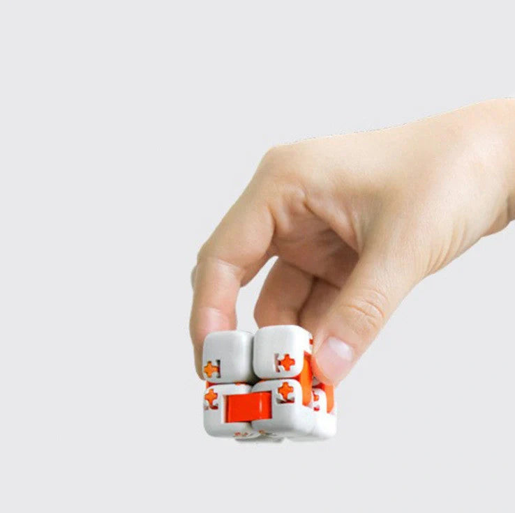 Mitu fidget building block toy in white, gray, and orange with zero draft technology for stress relief