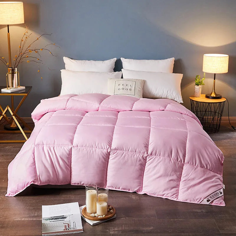 Goose down winter duvet in twill fabric showing colour options on a bed