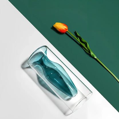 Transparent glass vase with colourful inner layer displaying dried flowers, 15cm tall on wooden table