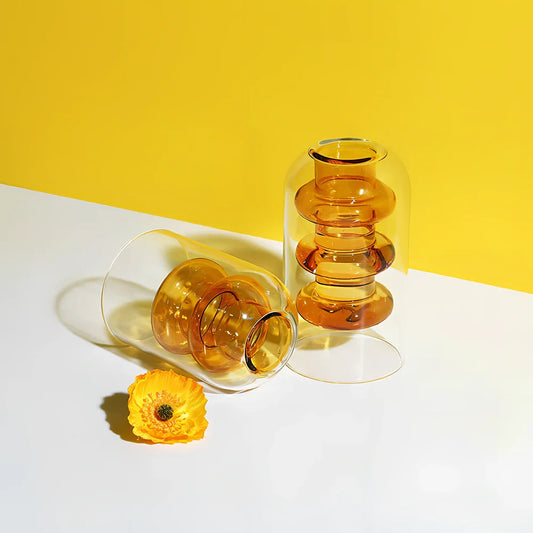 Transparent glass vase with colourful inner layer displaying dried flowers, 15cm tall on wooden table