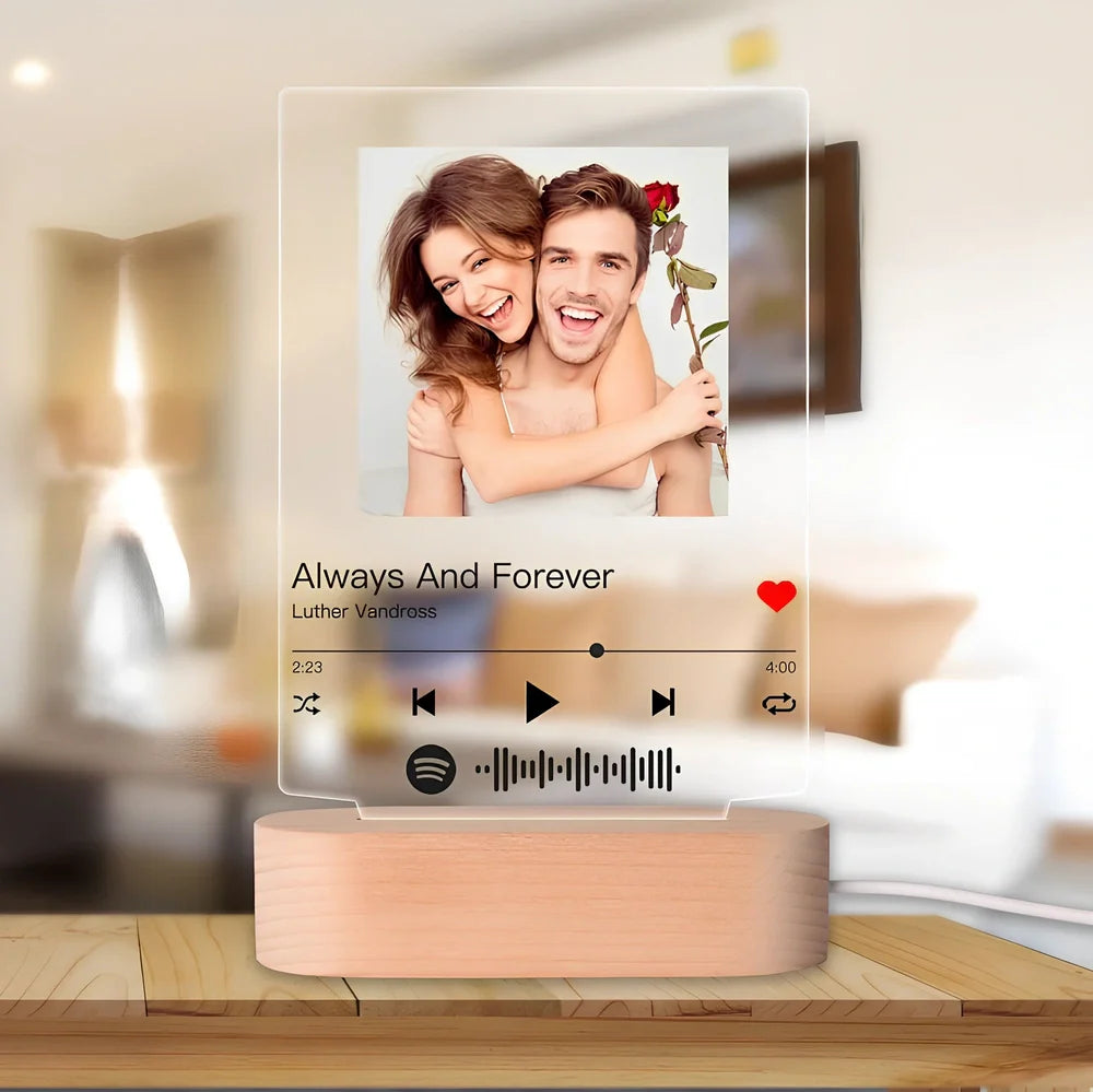 Customisable photo night light with 22x15cm acrylic panel showing engraved song lyrics beside personal photograph