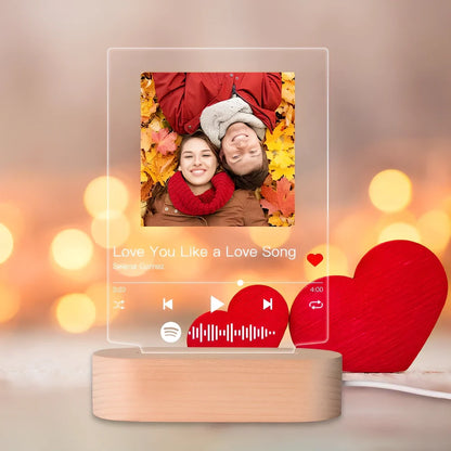 Customisable photo night light with 22x15cm acrylic panel showing engraved song lyrics beside personal photograph