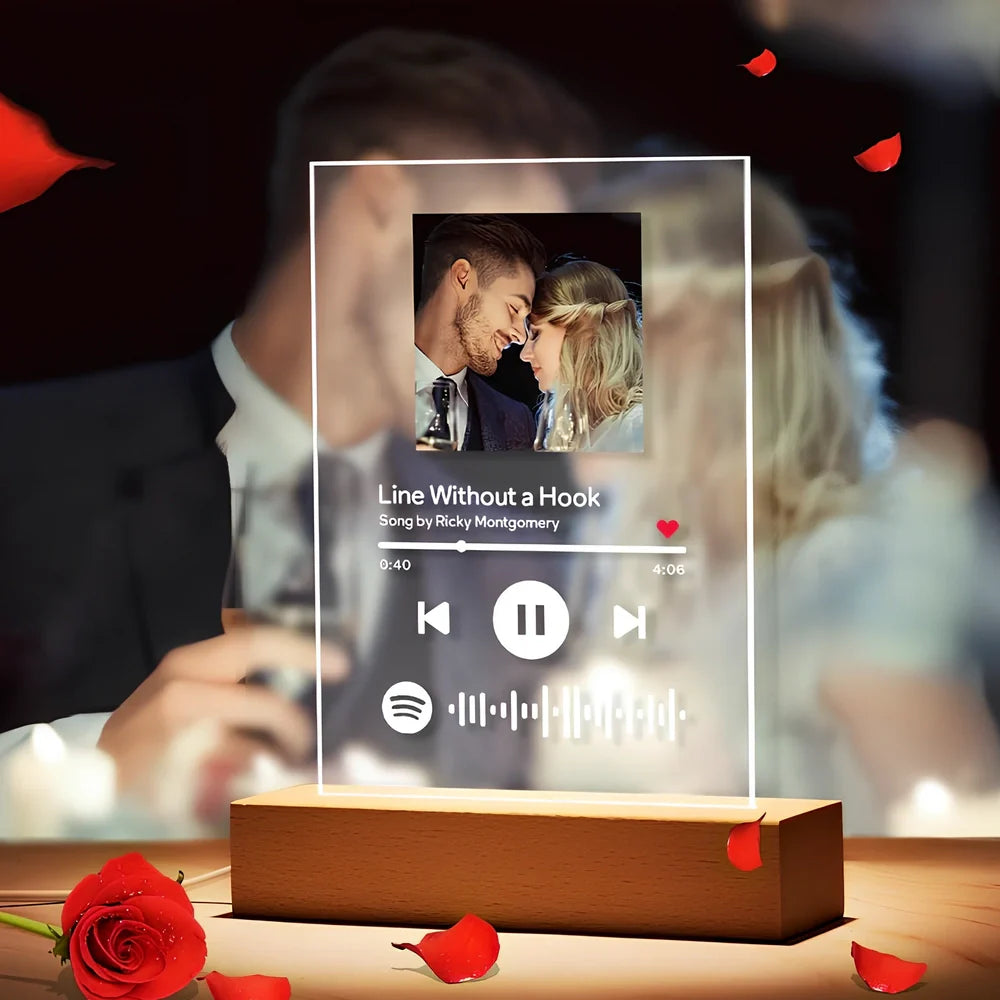 Customisable photo night light with 22x15cm acrylic panel showing engraved song lyrics beside personal photograph