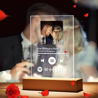 Customisable photo night light with 22x15cm acrylic panel showing engraved song lyrics beside personal photograph