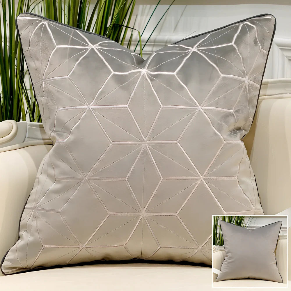Embroidered throw pillow with removable cover in plush fabric, showing detailed embroidery pattern