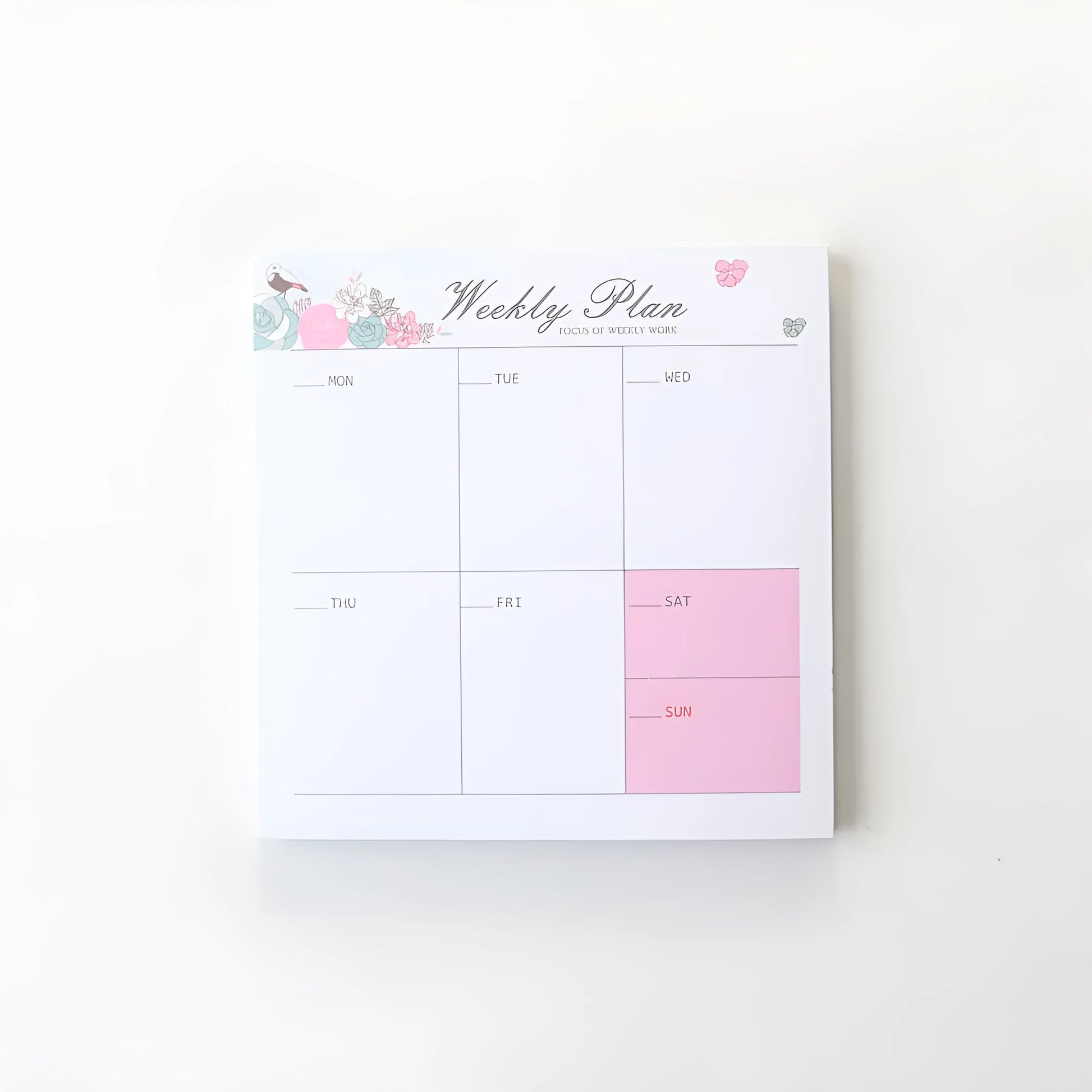 Domikee student desk organiser pad in pink and green with integrated weekly and monthly paper planners.
