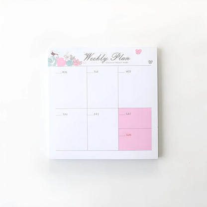 Domikee student desk organiser pad in pink and green with integrated weekly and monthly paper planners.