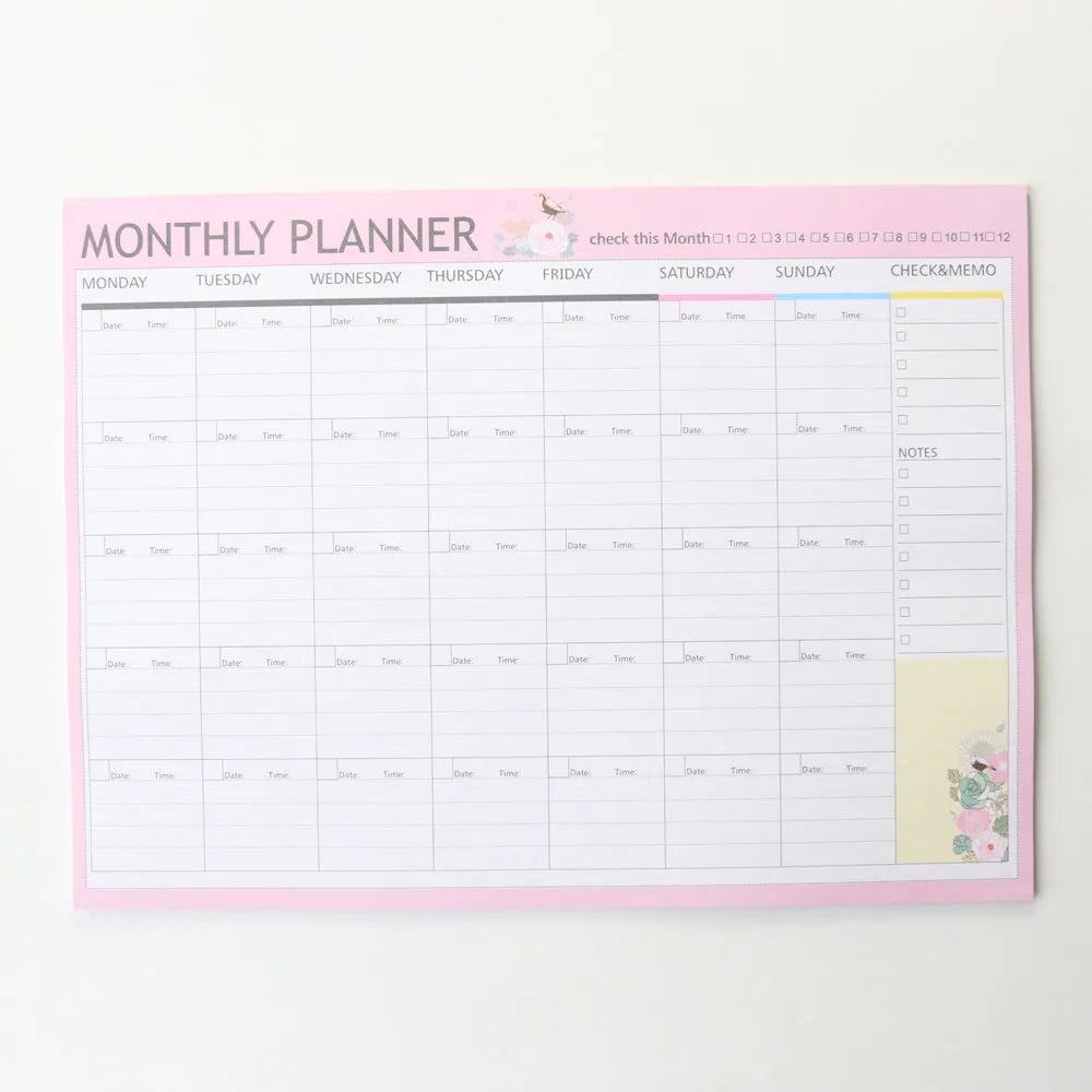 Domikee student desk organiser pad in pink and green with integrated weekly and monthly paper planners.