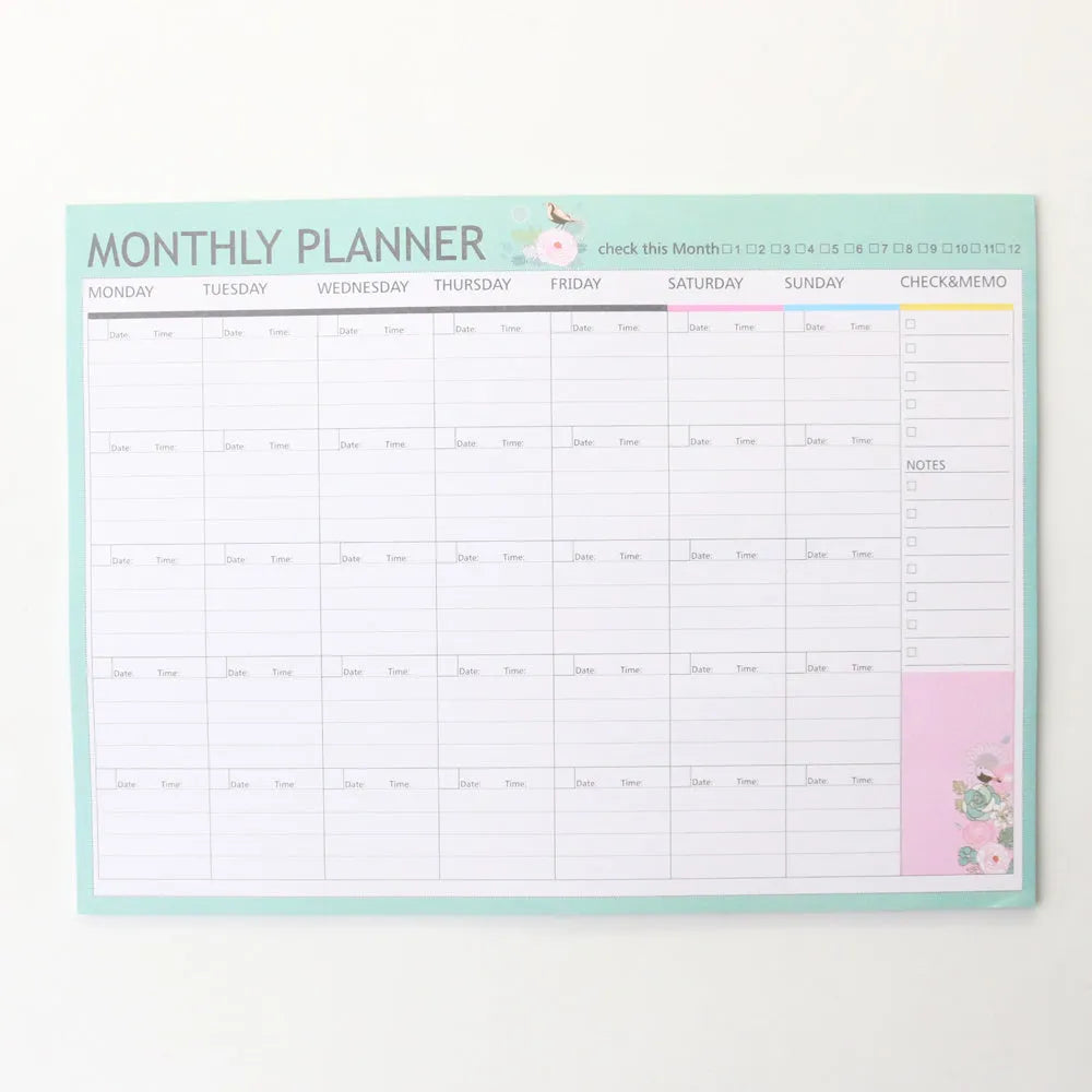 Domikee student desk organiser pad in pink and green with integrated weekly and monthly paper planners.