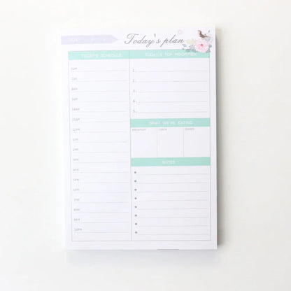 Domikee student desk organiser pad in pink and green with integrated weekly and monthly paper planners.