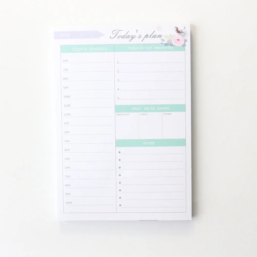 Domikee student desk organiser pad in pink and green with integrated weekly and monthly paper planners.
