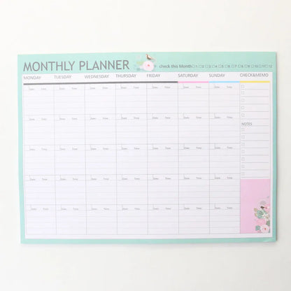 Domikee student desk organiser pad in pink and green with integrated weekly and monthly paper planners.