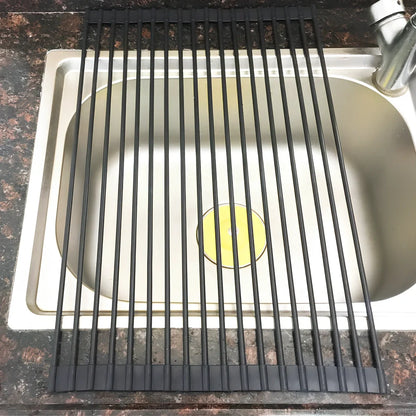 Black folding stainless steel sink drain rack with silicone edges, shown both unfolded for drying and folded for storage