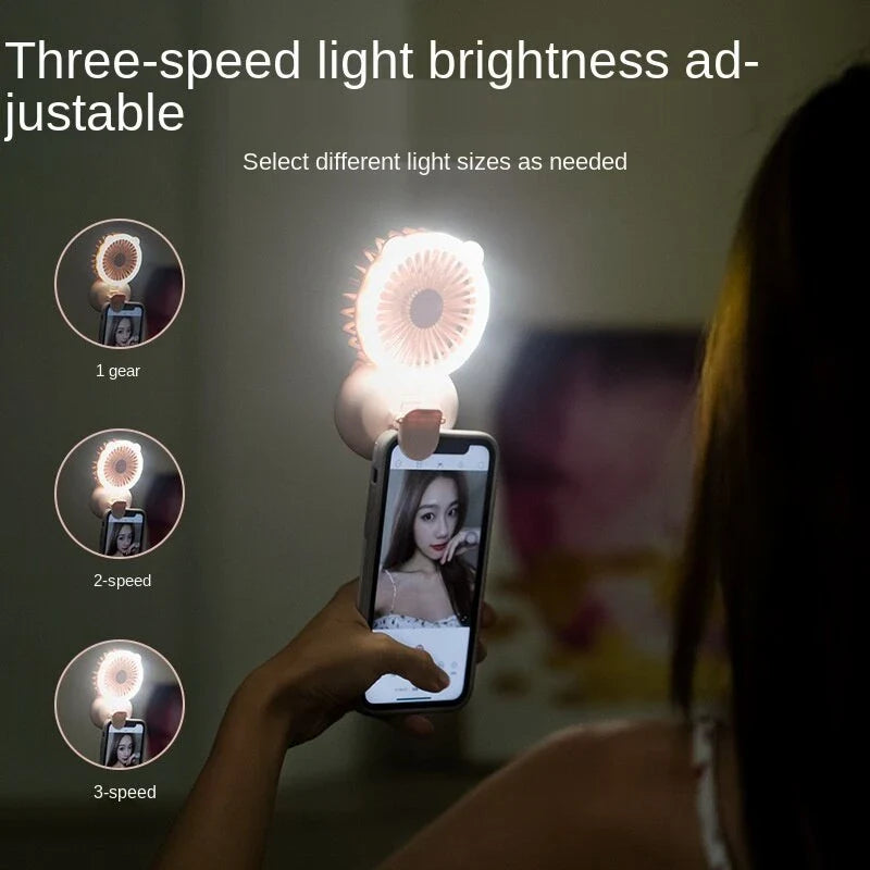 Portable USB-powered mini fan with LED fill light for taking selfies and videos in low-light conditions