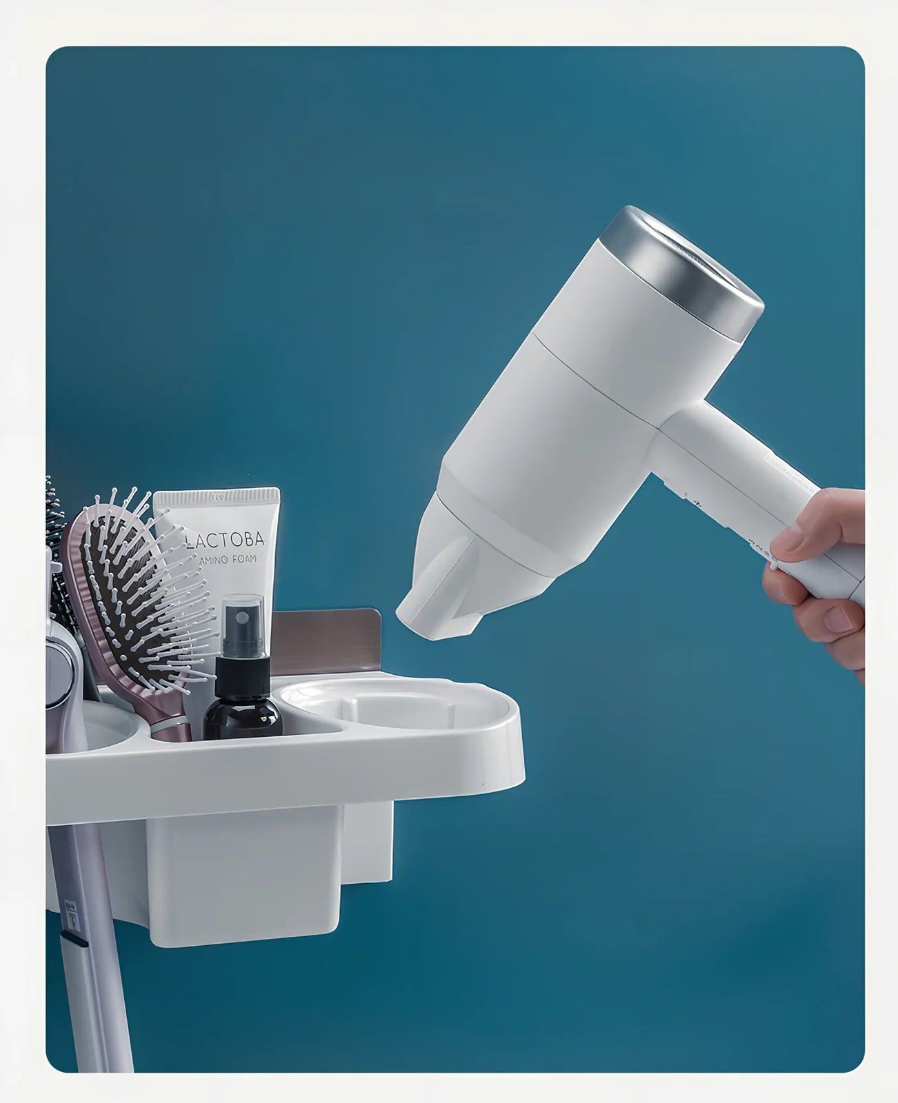 White plastic hair dryer storage rack with 20 compartments mounted on bathroom wall