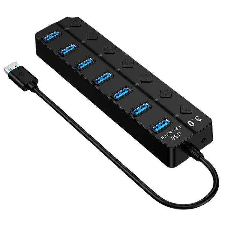 Black 7-port USB 3.0 hub with external power adapter on desktop