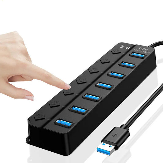 Black 7-port USB 3.0 hub with external power adapter on desktop