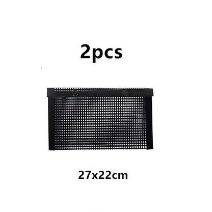 Black grill mesh bag with non-stick grid mat on barbecue, showing smoke circulation through mesh design