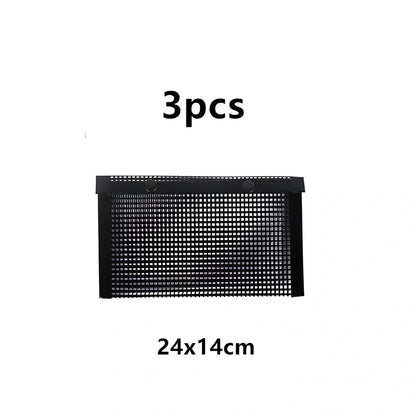 Black grill mesh bag with non-stick grid mat on barbecue, showing smoke circulation through mesh design