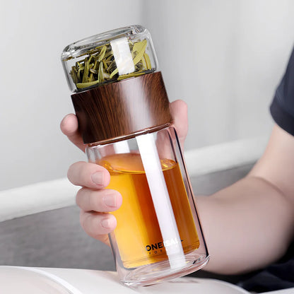 Wood grain separated tea cup with double-wall borosilicate construction and leak-proof lid showing measurement markings