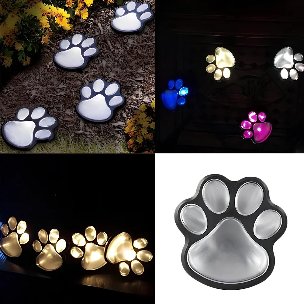 Four black paw-shaped solar garden lights with connecting wire and central solar panel for automatic outdoor illumination