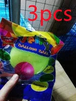 Large pink, yellow, green, and blue inflatable bouncy balls in various sizes for children's play.