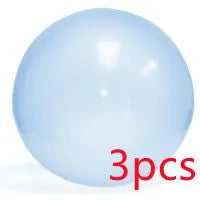 Large pink, yellow, green, and blue inflatable bouncy balls in various sizes for children's play.