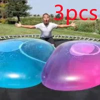 Large pink, yellow, green, and blue inflatable bouncy balls in various sizes for children's play.