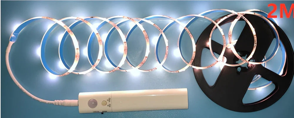 LED human induction bed lamp strip with remote control, 8mm width, showing yellow cut marks for custom length adjustment