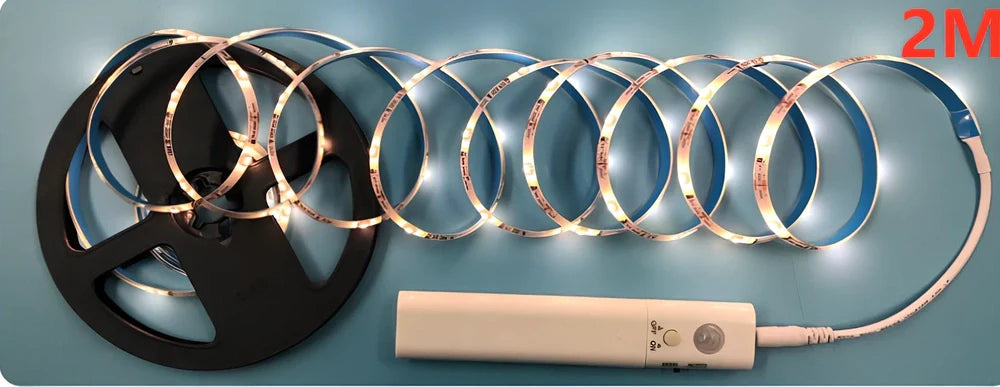LED human induction bed lamp strip with remote control, 8mm width, showing yellow cut marks for custom length adjustment
