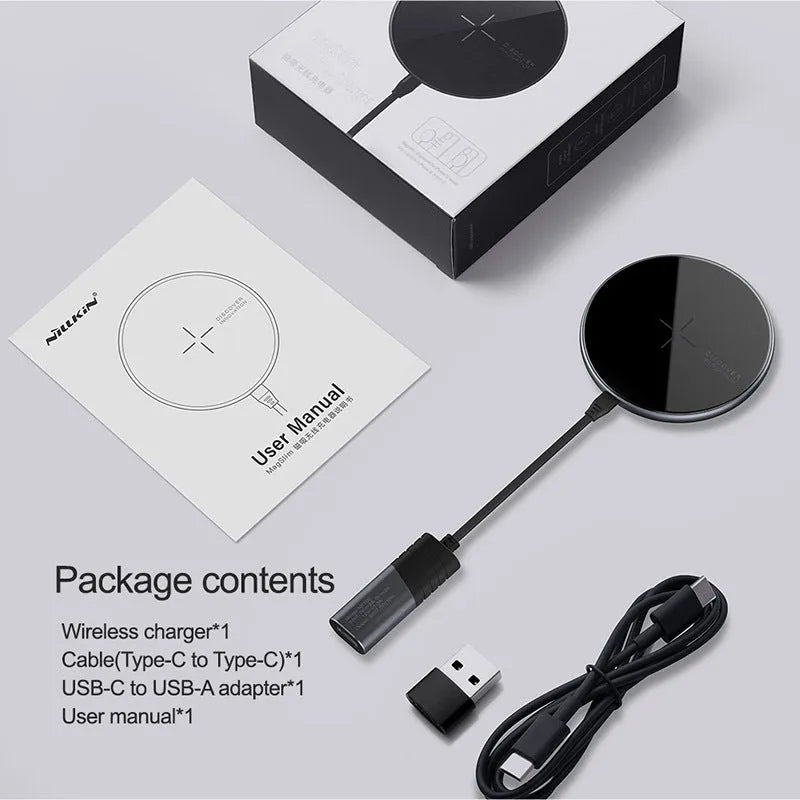 Black MagSlim magnetic wireless charging pad for phones on a table.