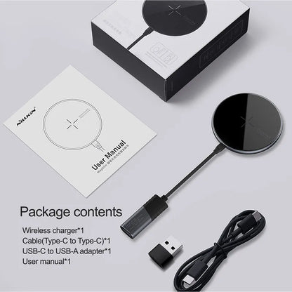 Black MagSlim magnetic wireless charging pad for phones on a table.