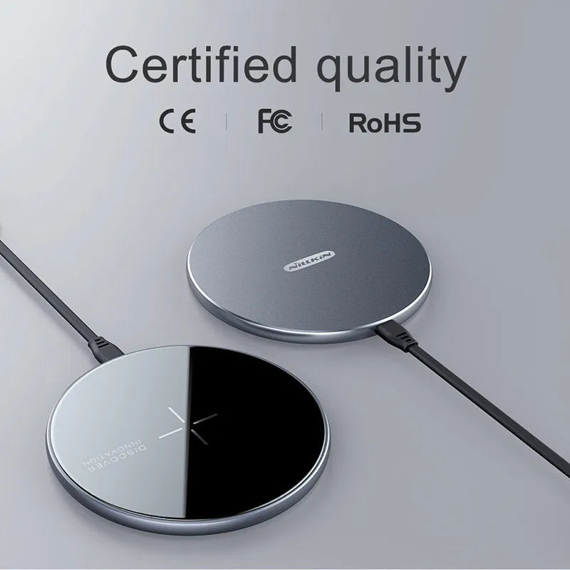 Black MagSlim magnetic wireless charging pad for phones on a table.