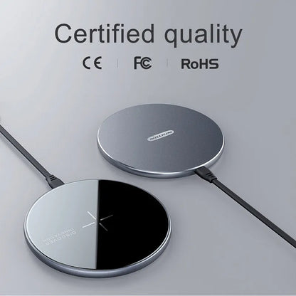 Black MagSlim magnetic wireless charging pad for phones on a table.