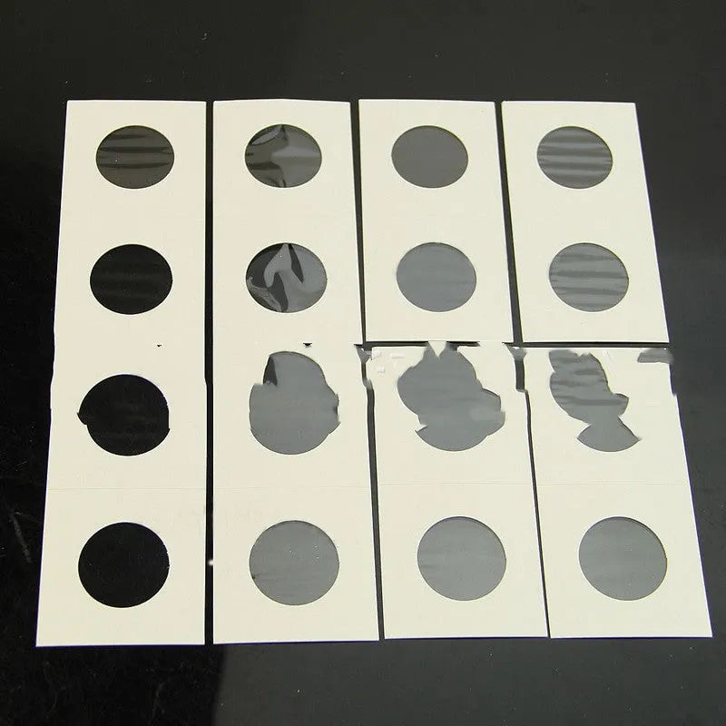 Set of 50 white paper coin protectors in transparent OPP packaging for commemorative coin storage