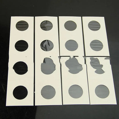 Set of 50 white paper coin protectors in transparent OPP packaging for commemorative coin storage