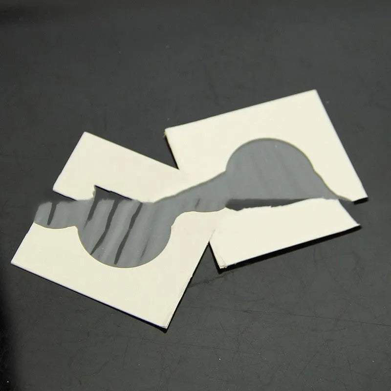 Set of 50 white paper coin protectors in transparent OPP packaging for commemorative coin storage