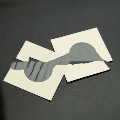 Set of 50 white paper coin protectors in transparent OPP packaging for commemorative coin storage