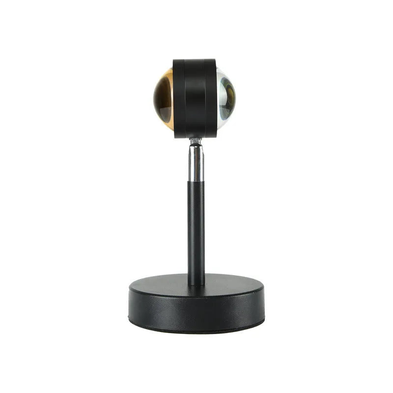 Black USB dual-head sunset rainbow projection lamp with touch controls on bedside table