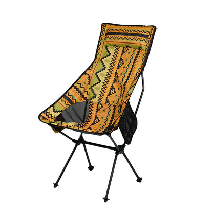 Red aluminium alloy folding moon chair unfolded on grass with folding mechanism visible