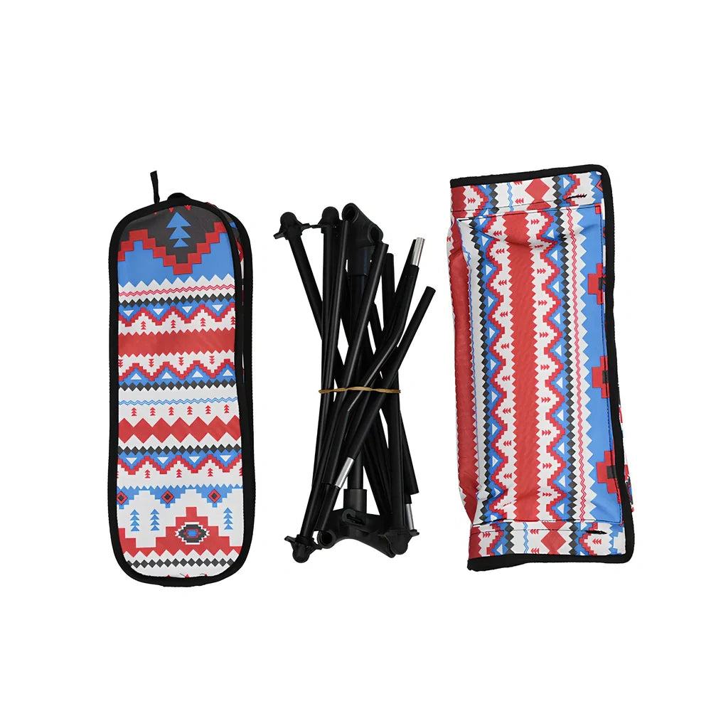 Red aluminium alloy folding moon chair unfolded on grass with folding mechanism visible