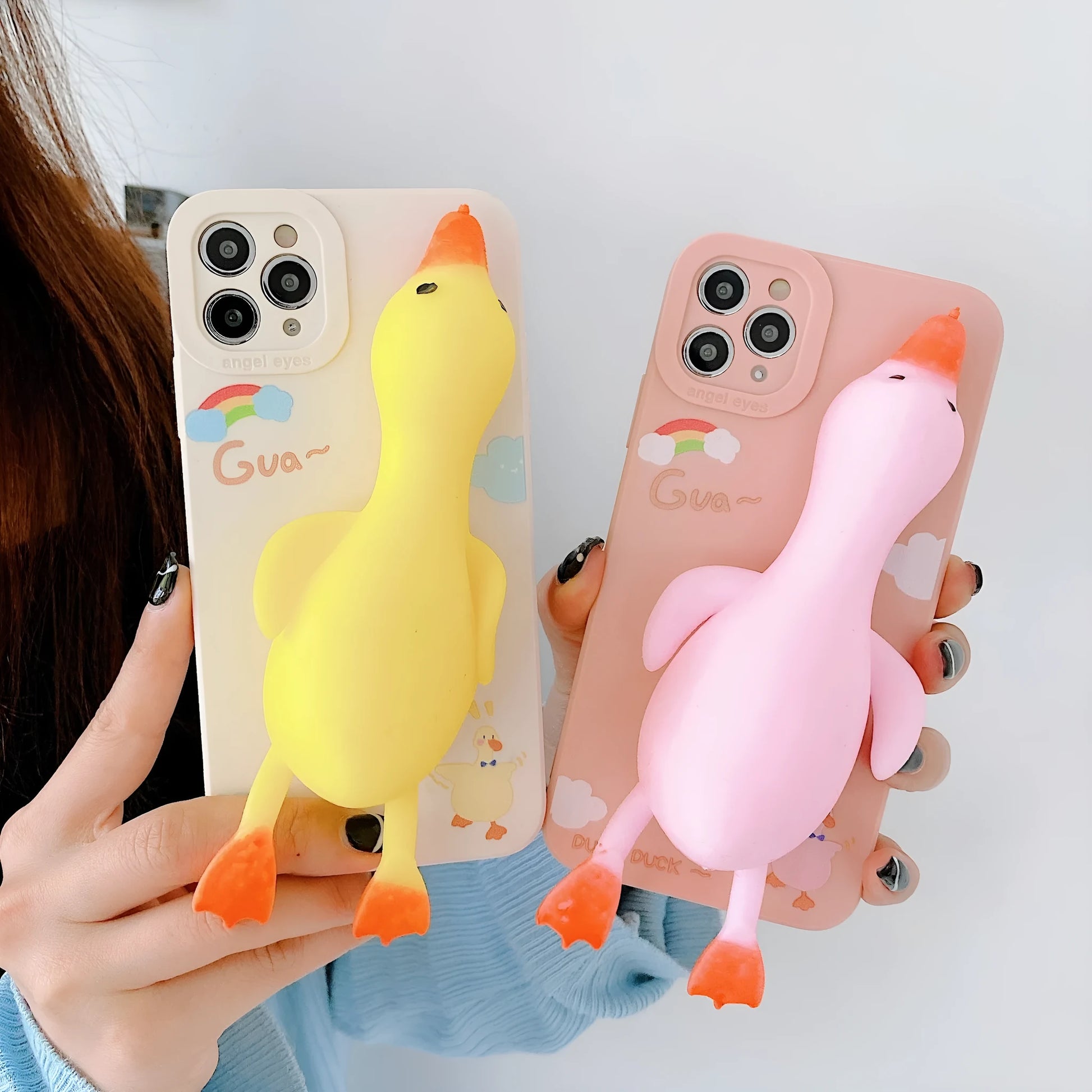 Cartoon print silicone phone case for iPhone in yellow, white, and pink colours.