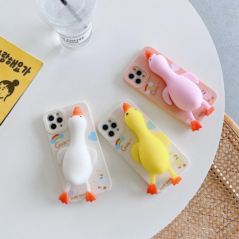 Silicone iPhone case with printed cartoon design, compatible with multiple Apple models including iPhone 7/8/SE, X/XS, XR, XS Max, 11, 11 Pro, 11 Pro Max, 12, 12 Pro, and 12 Pro Max, available in pinch duck yellow, white, and pink.