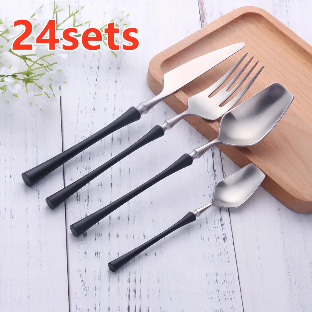 Four-piece stainless steel cutlery set showing main knife, fork, spoon, and teaspoon with mirror finish