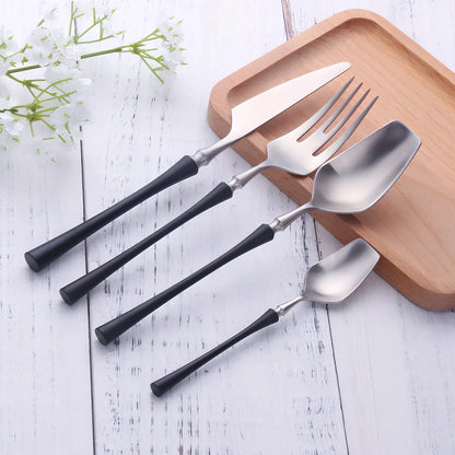Four-piece stainless steel cutlery set showing main knife, fork, spoon, and teaspoon with mirror finish